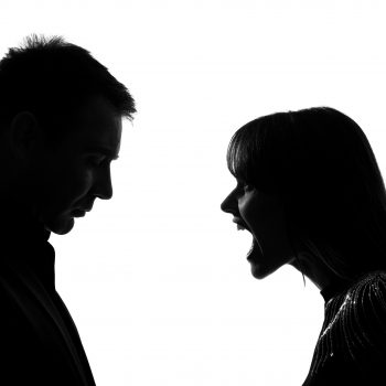 one caucasian couple man and woman face to face screaming shouting dipute in studio silhouette isolated on white background